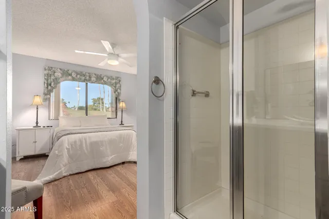 a en suite bathroom with a granite countertop sink and a mirror