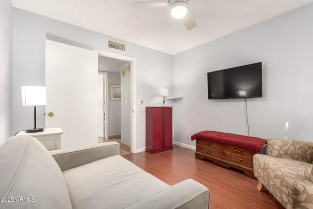 a bedroom with bed and a flat screen tv