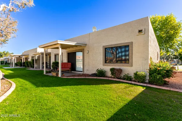 a view of a house with a yard porch and sitting area