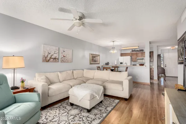 a living room with furniture and a wooden floor