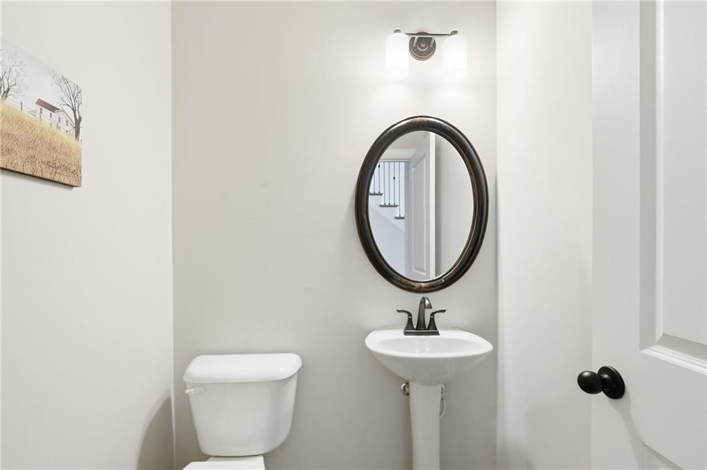 8840 Hightower Ridge Ball Ground, GA 30107 - Photo 12 of 74 a bathroom with a toilet a sink and a mirror