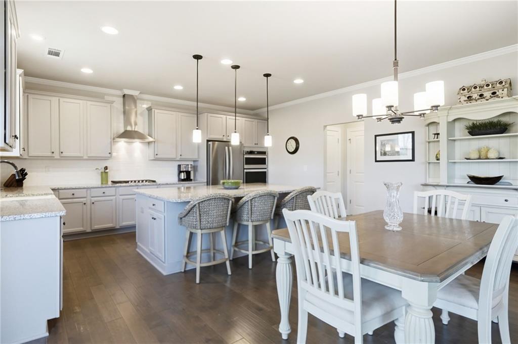 8840 Hightower Ridge Ball Ground, GA 30107 - Photo 16 of 74 a large kitchen with a table and chairs