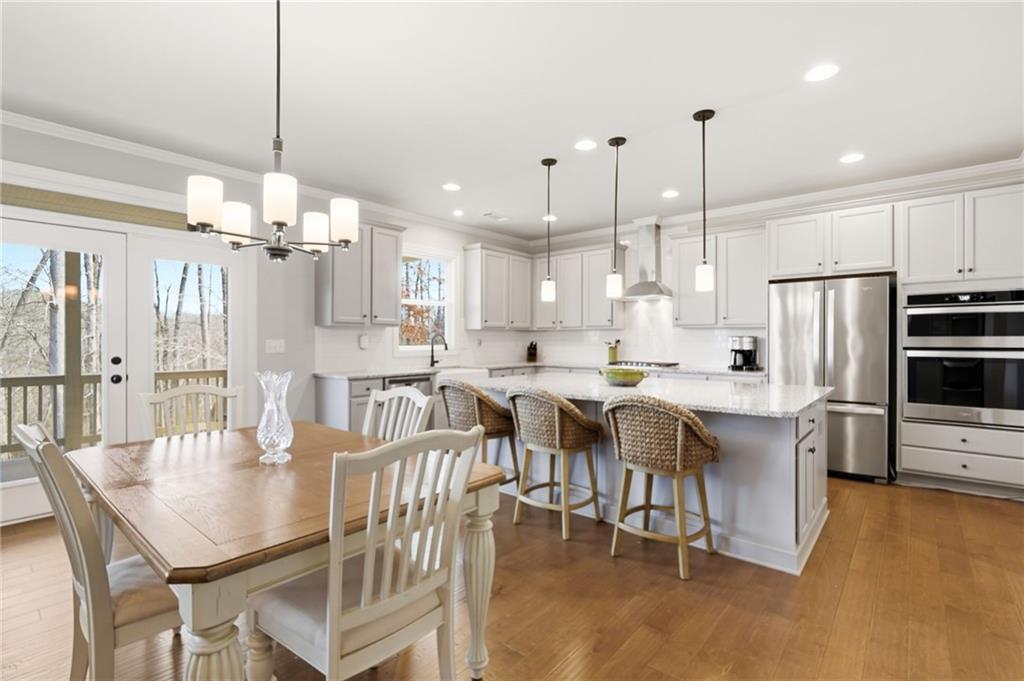 8840 Hightower Ridge Ball Ground, GA 30107 - Photo 17 of 74 a large kitchen with a table and chairs