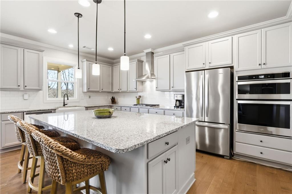 8840 Hightower Ridge Ball Ground, GA 30107 - Photo 18 of 74 a kitchen with granite countertop a white refrigerator oven a sink and cabinets