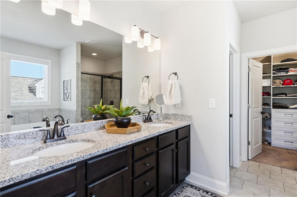 8840 Hightower Ridge Ball Ground, GA 30107 - Photo 25 of 74 a bathroom with a granite countertop sink and a mirror