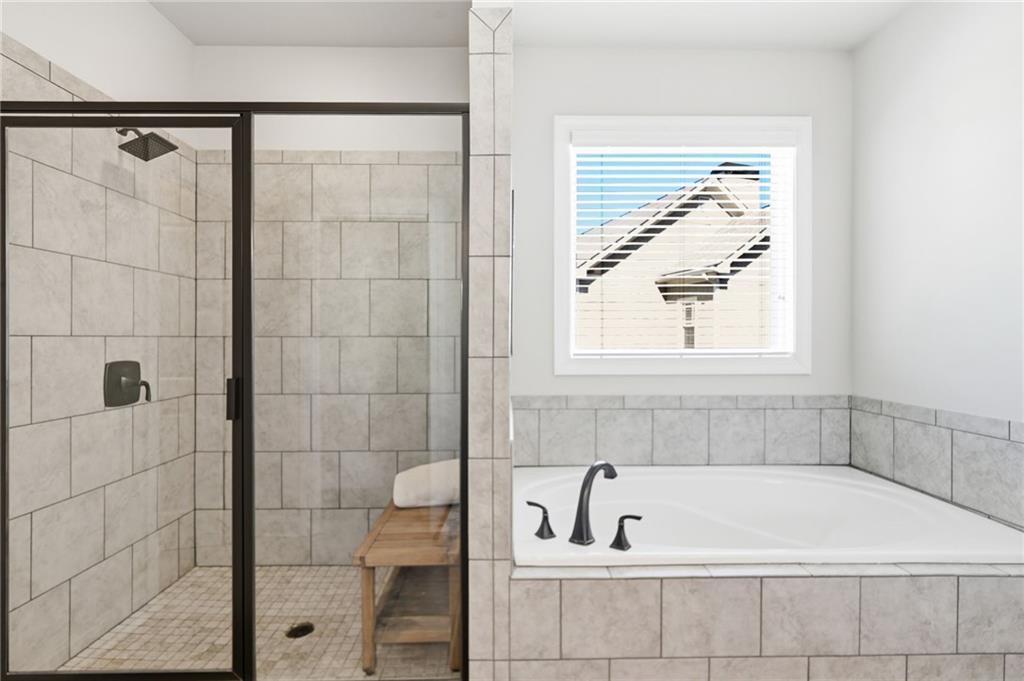 8840 Hightower Ridge Ball Ground, GA 30107 - Photo 26 of 74 a bathroom with a bathtub and shower