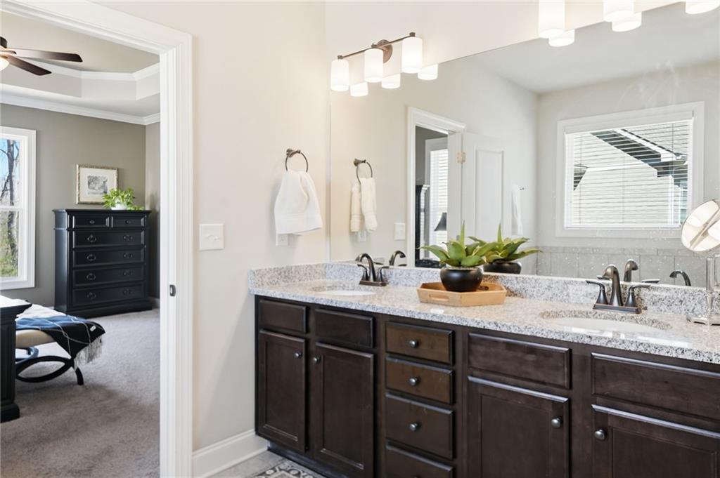 8840 Hightower Ridge Ball Ground, GA 30107 - Photo 27 of 74 a en suite bathroom with a granite countertop sink and a mirror