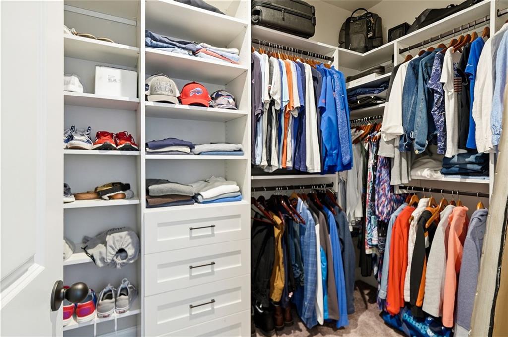 8840 Hightower Ridge Ball Ground, GA 30107 - Photo 28 of 74 a view of walk in closet with clothes and shoes