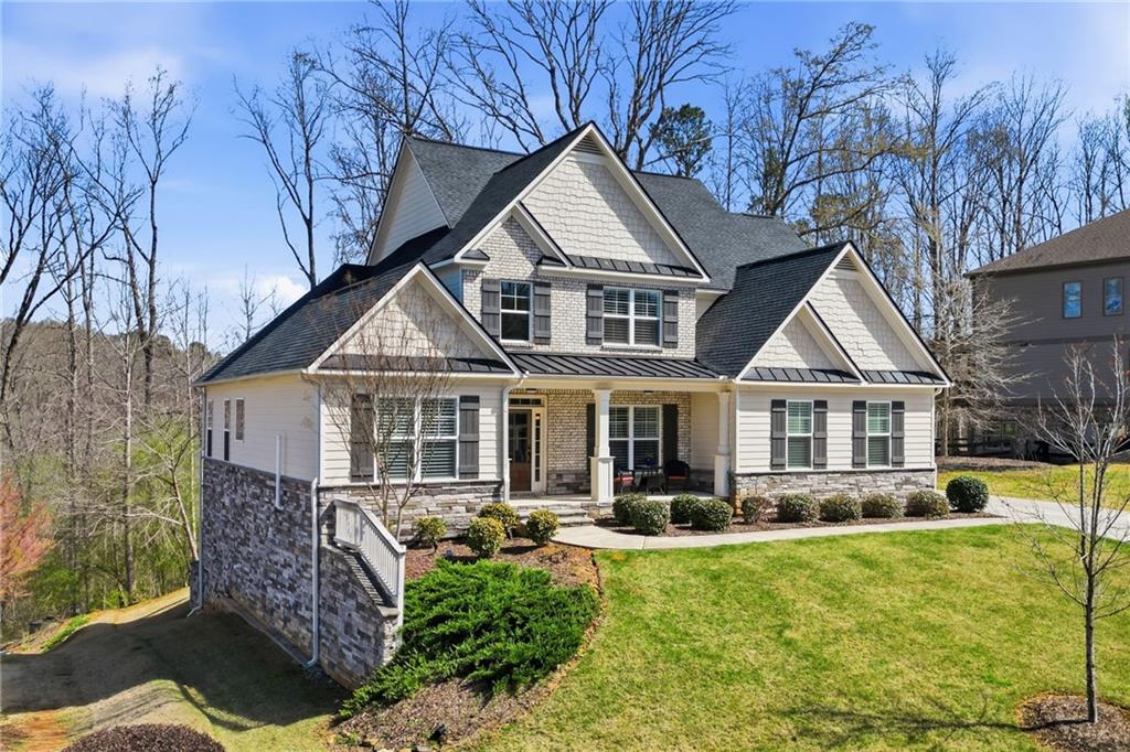 8840 Hightower Ridge Ball Ground, GA 30107 - Photo 3 of 74 a front view of a house with yard porch and furniture