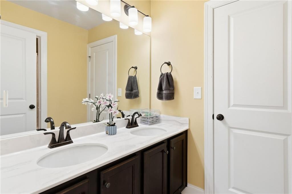 8840 Hightower Ridge Ball Ground, GA 30107 - Photo 37 of 74 a bathroom with double sink and a mirror