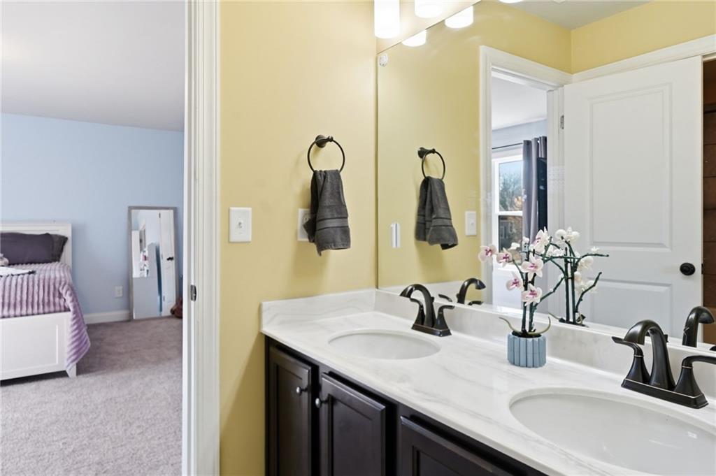 8840 Hightower Ridge Ball Ground, GA 30107 - Photo 39 of 74 a bathroom with a double vanity sink and a mirror