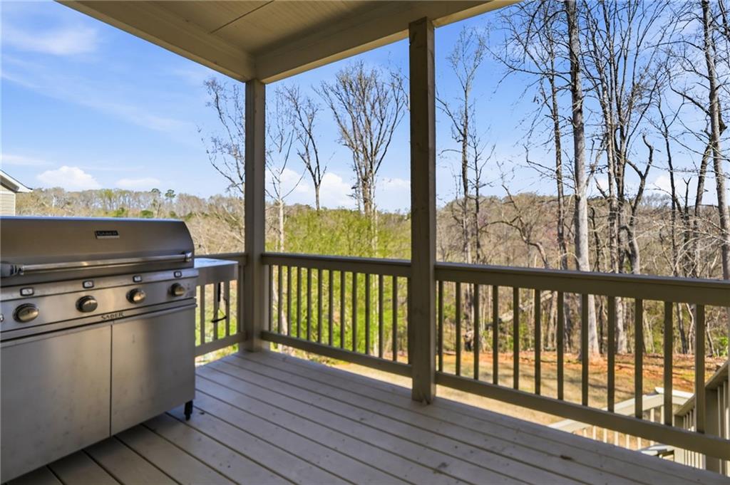 8840 Hightower Ridge Ball Ground, GA 30107 - Photo 47 of 74 a view of a room with wooden floor and iron stairs