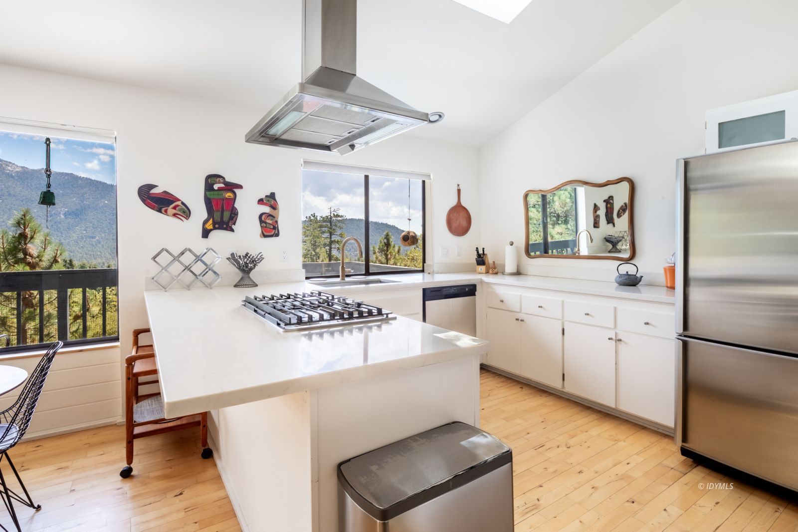 23916 Highway 243 Idyllwild, CA 92549 - Photo 17 of 47 a kitchen with stainless steel appliances granite countertop a refrigerator a sink a stove and white cabinets