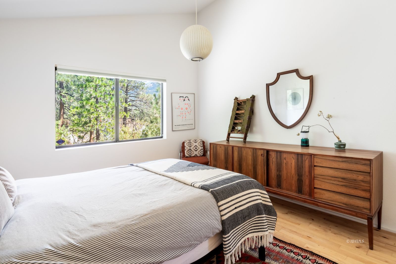 23916 Highway 243 Idyllwild, CA 92549 - Photo 31 of 47 a bedroom with a bed and a chandelier