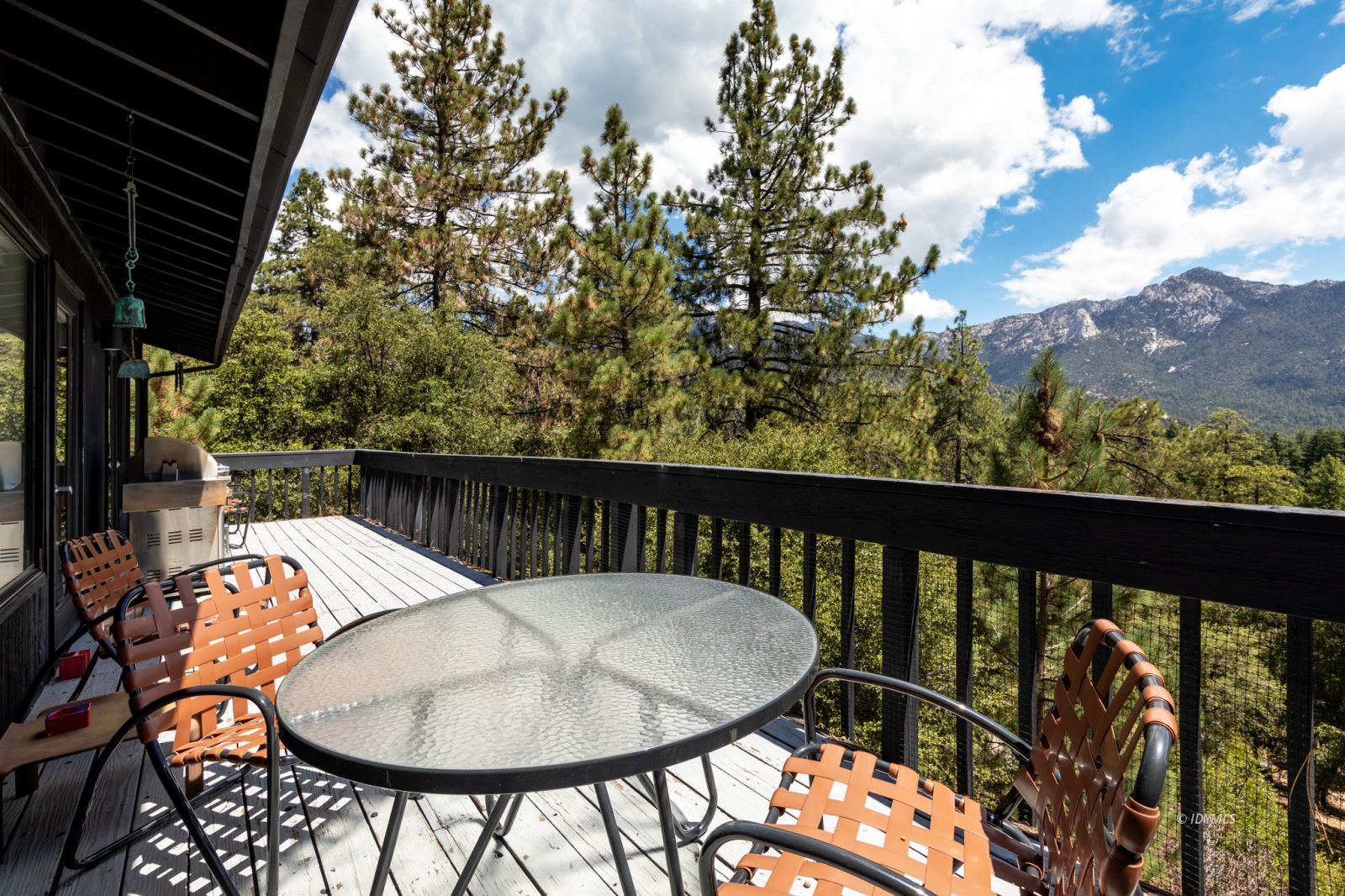 23916 Highway 243 Idyllwild, CA 92549 - Photo 46 of 47 a balcony with a potted plant and outdoor seating