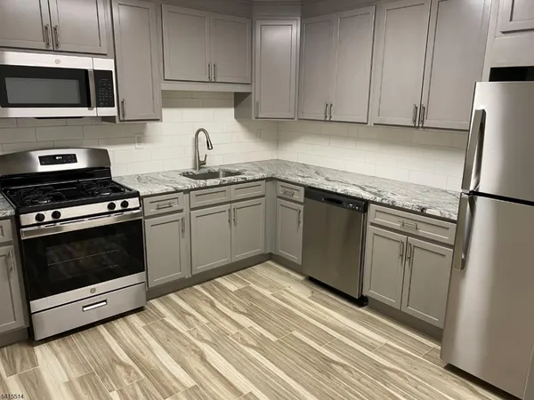 a kitchen with a sink stove and refrigerator
