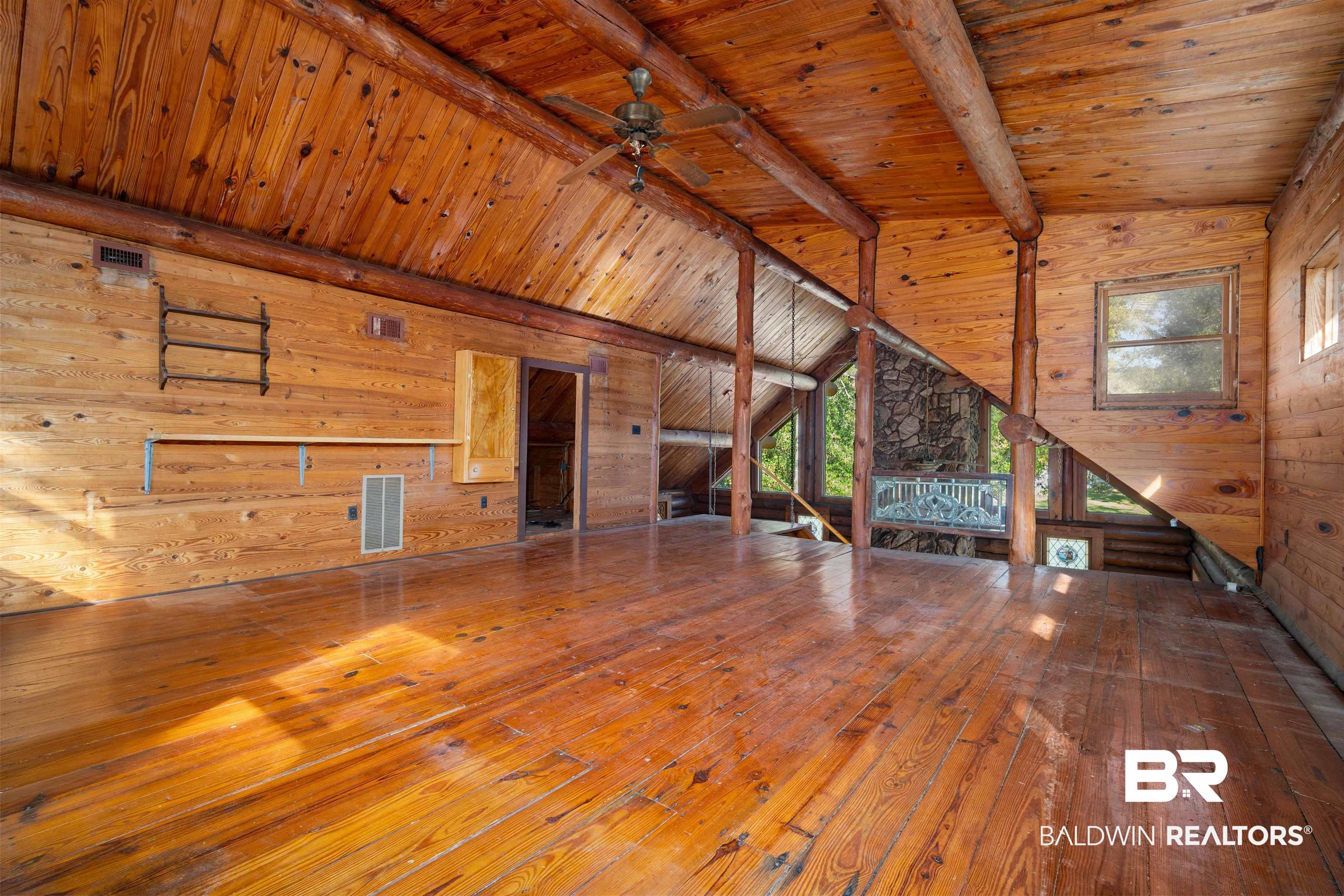 11236 Wren Avenue Fairhope, AL 36532 - Photo 16 of 35 Unfurnished living room featuring wooden walls, wood ceiling, hardwood / wood-style floors, and ceiling fan