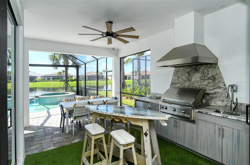 18114 Waterville Place Bradenton, FL 34202 - Photo 11 of 57 a dining room with a table chairs and a floor to ceiling window