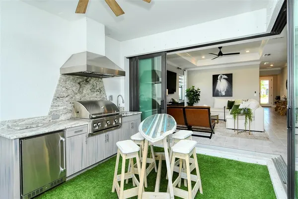 a kitchen with a refrigerator a sink and a stove top oven