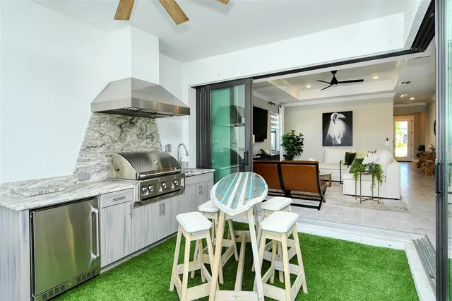 a kitchen with a refrigerator a sink and a stove top oven