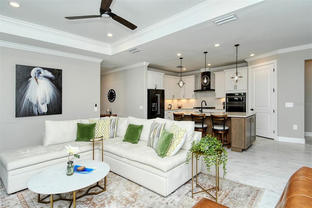 18114 Waterville Place Bradenton, FL 34202 - Photo 23 of 57 a living room with furniture and kitchen view