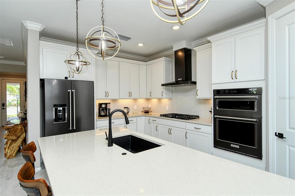 18114 Waterville Place Bradenton, FL 34202 - Photo 24 of 57 a kitchen with stainless steel appliances a stove a refrigerator and cabinets