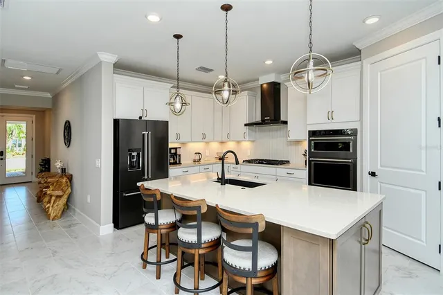 a bath tub sitting next to a white sink and vanity
