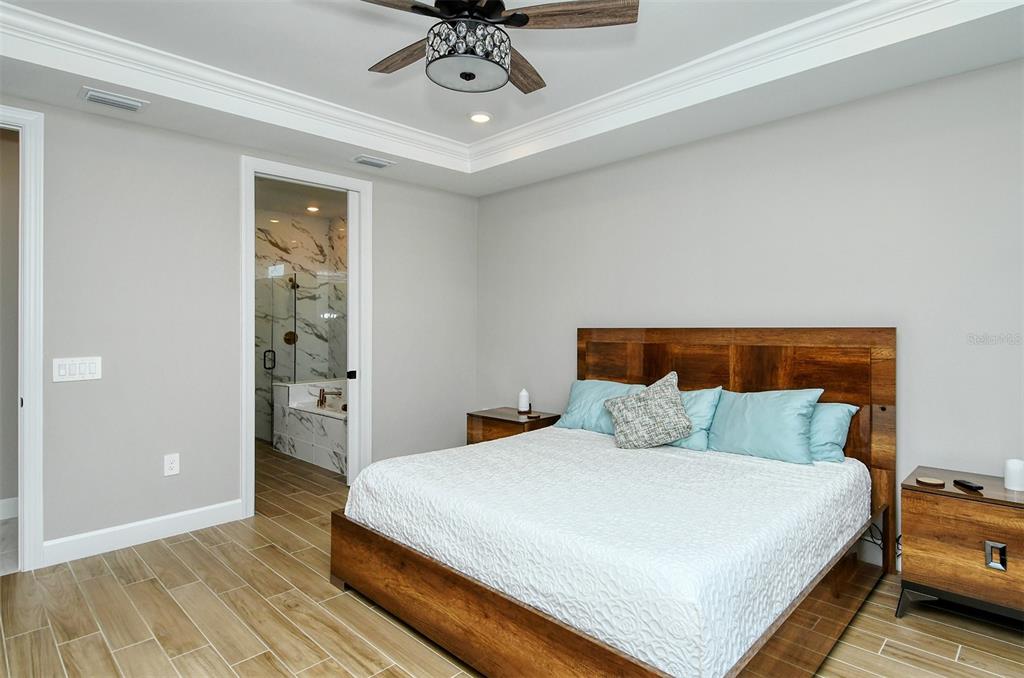 18114 Waterville Place Bradenton, FL 34202 - Photo 29 of 57 a bedroom with a bed and wooden floor