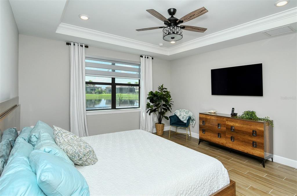 18114 Waterville Place Bradenton, FL 34202 - Photo 34 of 57 a bedroom with a bed and a flat screen tv