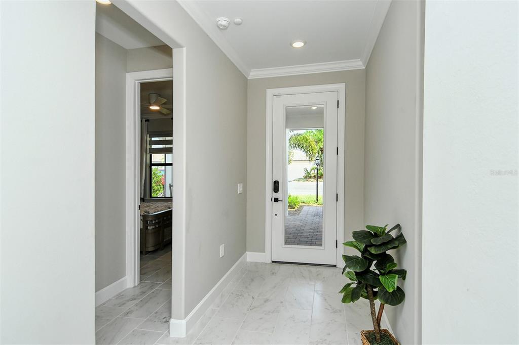 18114 Waterville Place Bradenton, FL 34202 - Photo 38 of 57 a view of an entryway with wooden floor and a potted plant