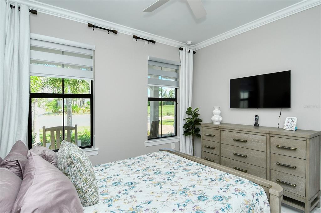 18114 Waterville Place Bradenton, FL 34202 - Photo 40 of 57 a bedroom with a bed and a flat screen tv in it