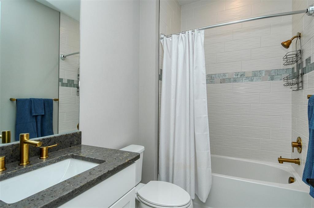 18114 Waterville Place Bradenton, FL 34202 - Photo 41 of 57 a bathroom with a granite countertop sink toilet and shower