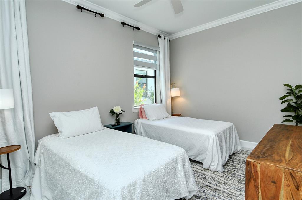 18114 Waterville Place Bradenton, FL 34202 - Photo 42 of 57 a bedroom with two beds and painted walls