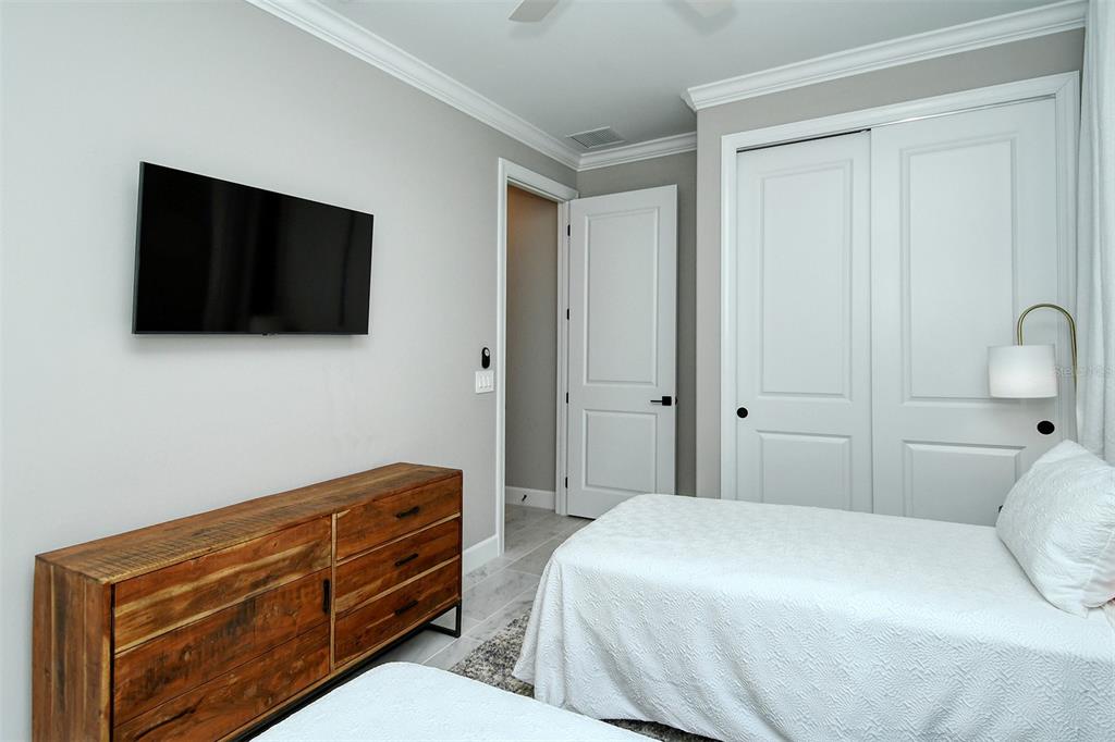 18114 Waterville Place Bradenton, FL 34202 - Photo 43 of 57 a bedroom with a bed and a flat screen tv