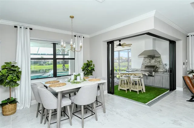 a dining room with furniture a chandelier and wooden floor