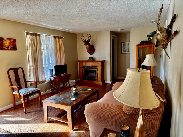 a living room with furniture fireplace and window