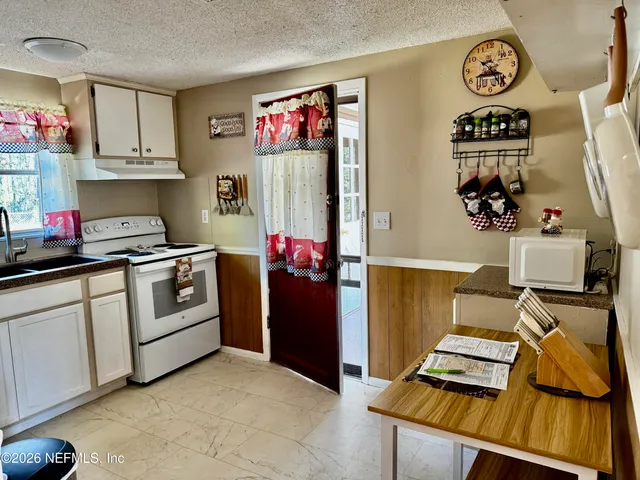 a kitchen with a refrigerator and cabinets
