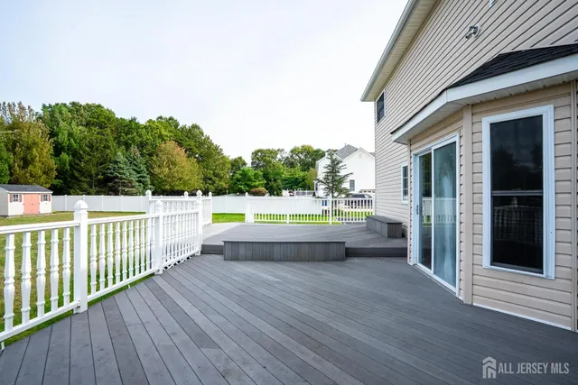 a view of a room with wooden staircase and ceiling fan
