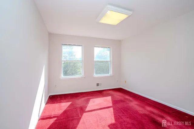 a bathroom with a tub shower sink and mirror