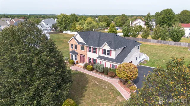 an aerial view of a house with a garden and swimming pool