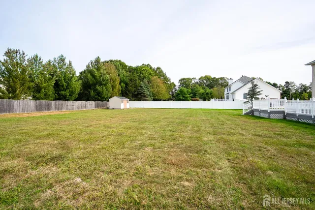 a front view of a house with a garden and swimming pool