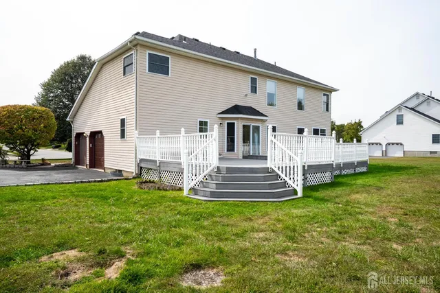a view of a house with a wooden deck