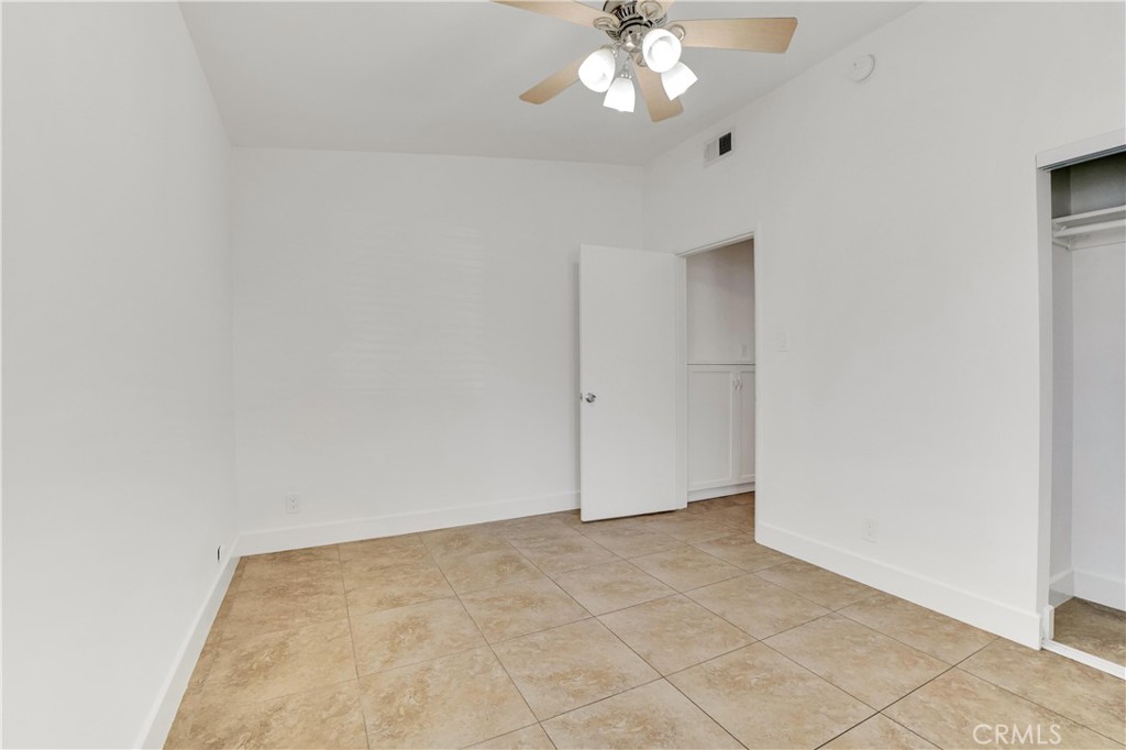 20300 Sherman Way Winnetka, CA 91306 - Photo 13 of 33 an empty room with a chandelier fan