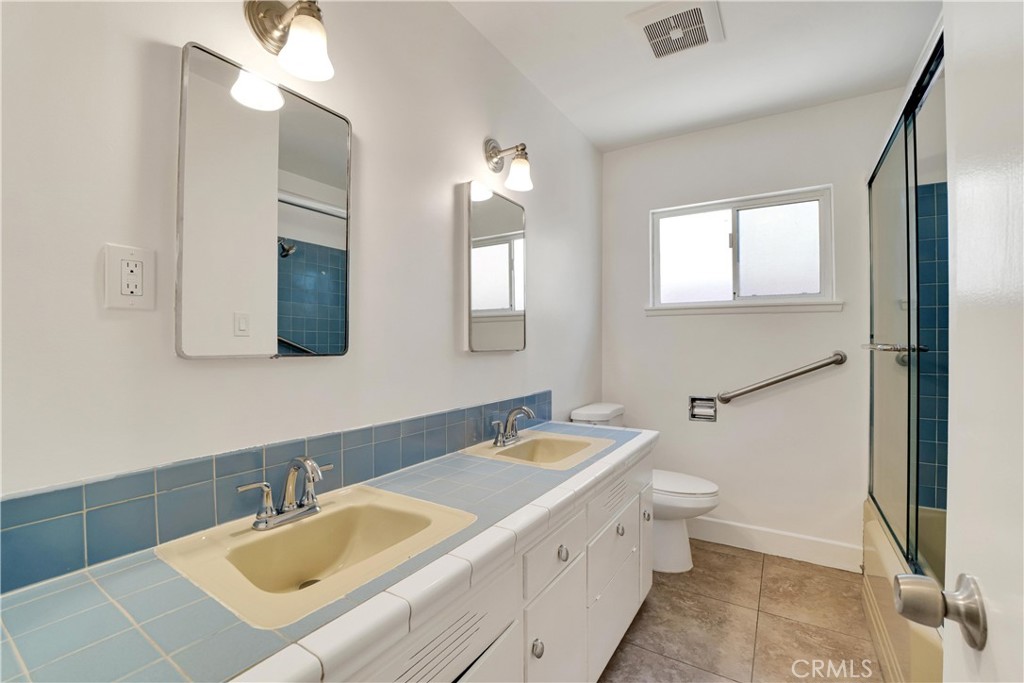 20300 Sherman Way Winnetka, CA 91306 - Photo 19 of 33 a bathroom with a sink and a mirror