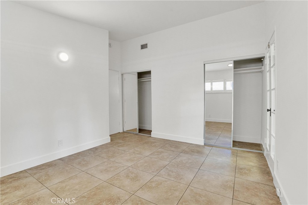 20300 Sherman Way Winnetka, CA 91306 - Photo 21 of 33 an empty room with kitchen space and windows