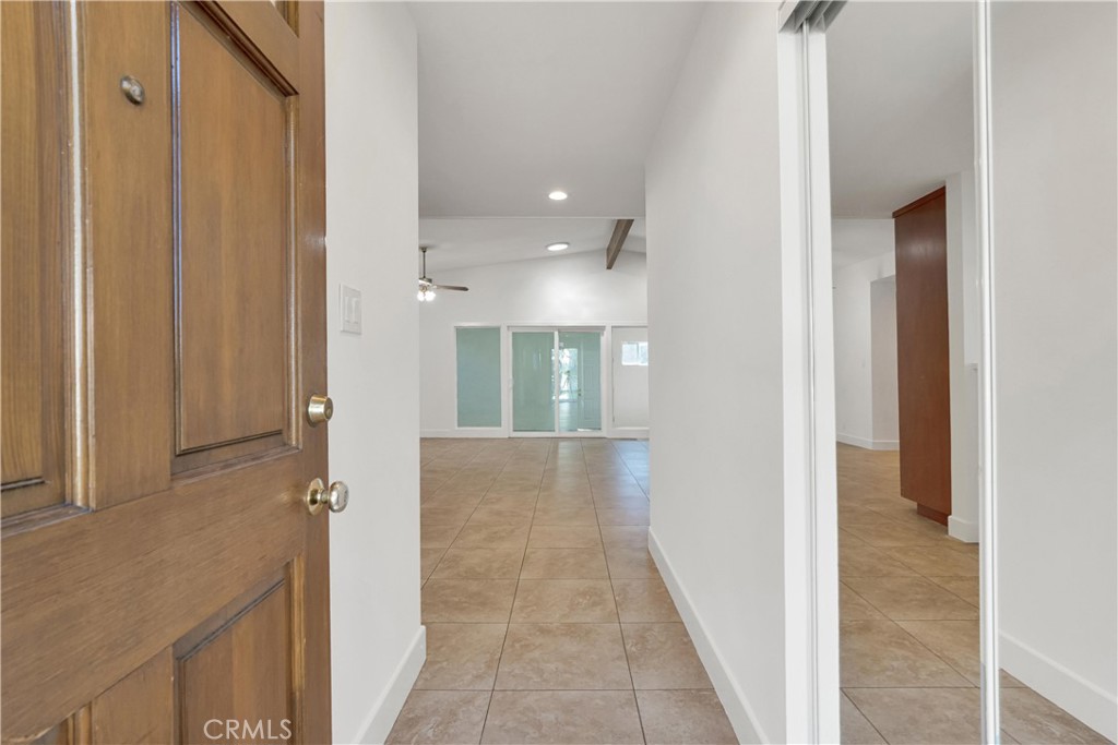 20300 Sherman Way Winnetka, CA 91306 - Photo 4 of 33 a view of a hallway with wooden floor and staircase