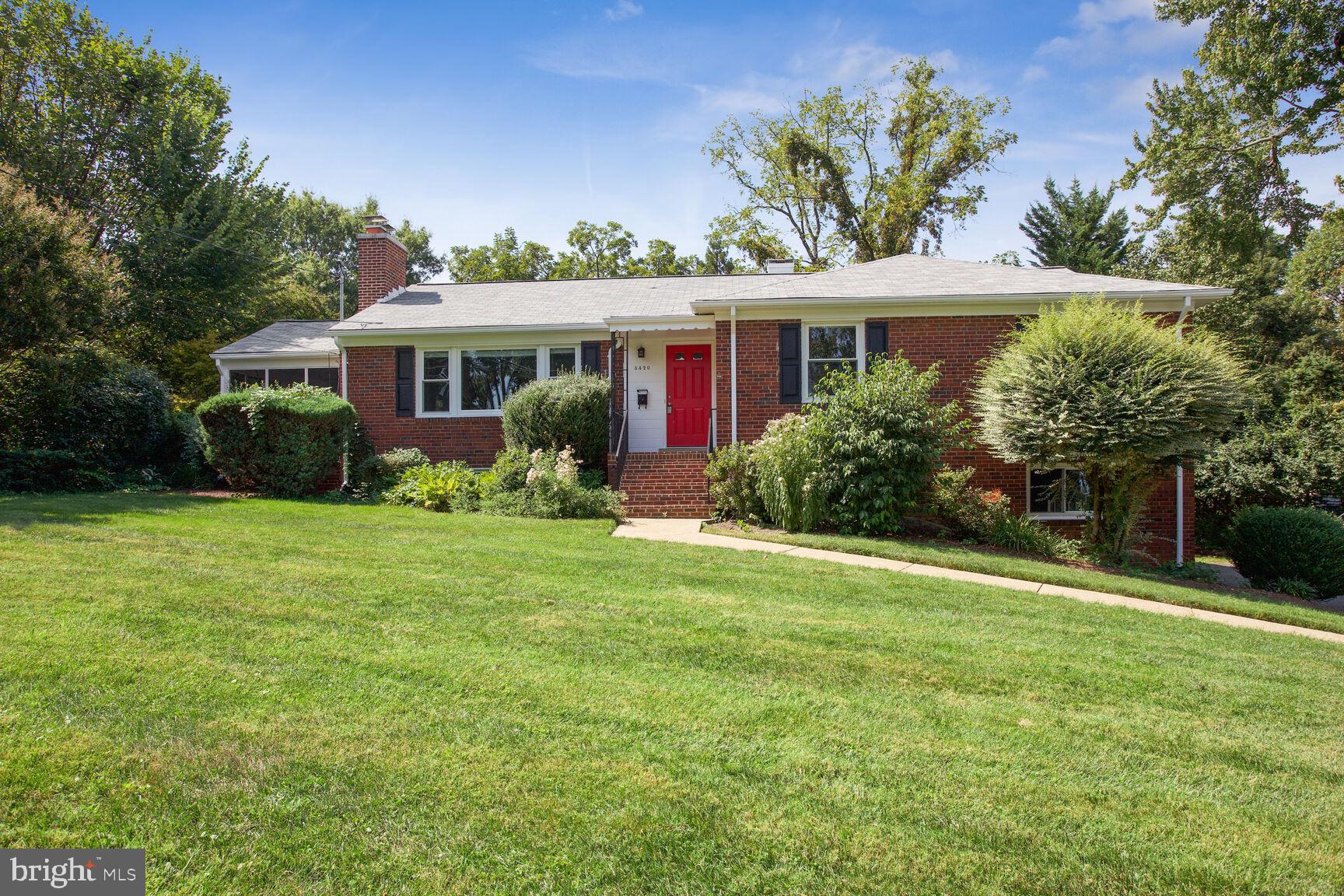 a front view of house with yard and green space