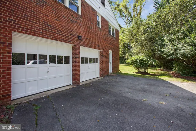 a view of a house with a yard and garage