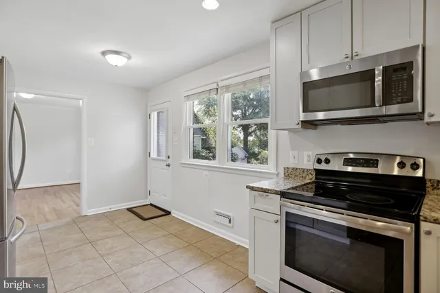 a kitchen with a stove and a microwave