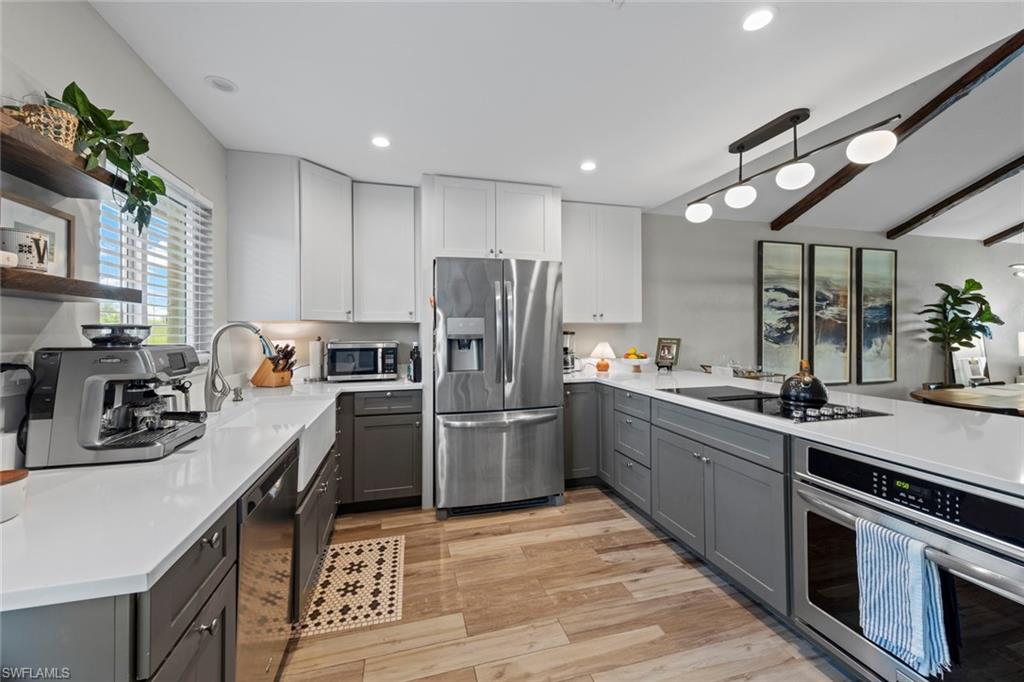 843 Palm View Drive, Unit 25 Naples, FL 34110 - Photo 12 of 27 a kitchen with a sink stainless steel appliances and cabinets